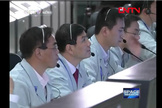 Chinese Mission Controllers watch as the Tiangong 1 spacecraft makes the country's first docking maneuver with Shenzhou 8.