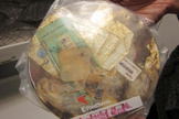 This condensed block of space garbage includes food solids and wrappers. The block will be on display in the American Museum of Natural History's 'Beyond Planet Earth' show.