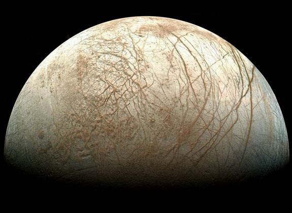 Europa, as viewed from NASA’s Galileo spacecraft. Visible are plains of bright ice, cracks that run to the horizon, and dark patches that likely contain both ice and dirt.