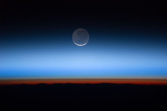 Astronauts aboard the International Space Station took this image showing Earth's atmosphere and moon on July 31, 2011.