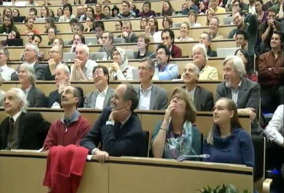 Physicists at the CERN laboratory in Geneva, Switzerland view a presentation of the data collected so far in the search for the Higgs boson particle at the Large Hadron Collider's ATLAS experiment.