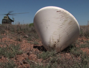 This image shows a re-entry capsule similar to one used on Russia's Phobos-Grunt Mars moon probe after a drop test. The capsule was designed to return samples of the Mars moon Phobos to Earth of the Phobos-Grunt mission succeeded.