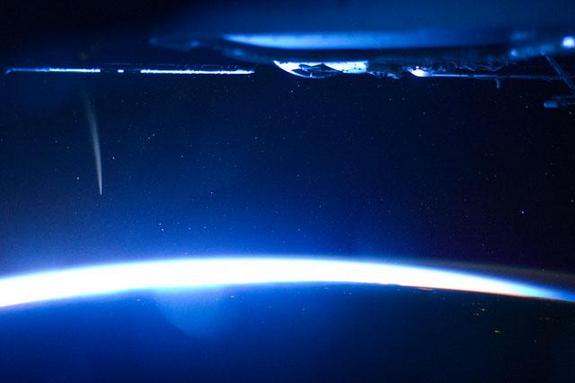 Comet Lovejoy is visible near Earth’s horizon in this nighttime image photographed by NASA astronaut Dan Burbank, Expedition 30 commander, onboard the International Space Station on Dec. 21, 2011.