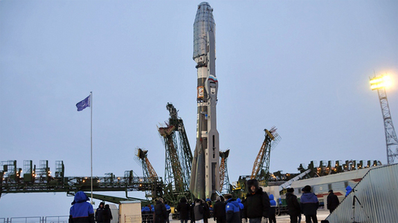 A Soyuz rocket is readied for its cold weather launch from Baikonur Cosmodrome on Dec. 28, 2011 with the latest cluster of Globalstar second-generation spacecraft. Visible at left and right is the two-piece “frame” service tower system that will be raised from its current horizontal position into place around the launcher.