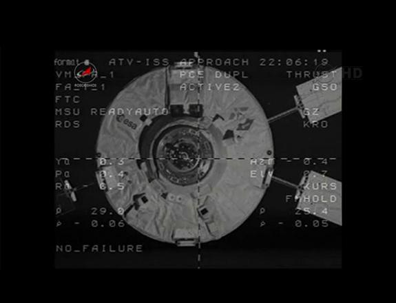 The European Space Agency's ATV-3 approaches the hatch of the Zvezda service module on the Russian segment of the International Space Station on March 28, 2012.