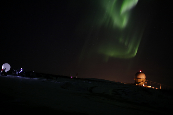 Researchers prepare to launch an instrument-laden weather balloon toward Alaska's aurora on April 12, 2012 (at right is a radar facility).