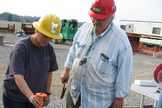 Mary Voytek and Greg Gohn of the USGS select a section of a freshly-retrieved core for biological sampling.