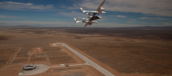 Virgin Galactic's high-flying WhiteKnightTwo mothership cradles SpaceShipTwo over New Mexico's Spaceport America.