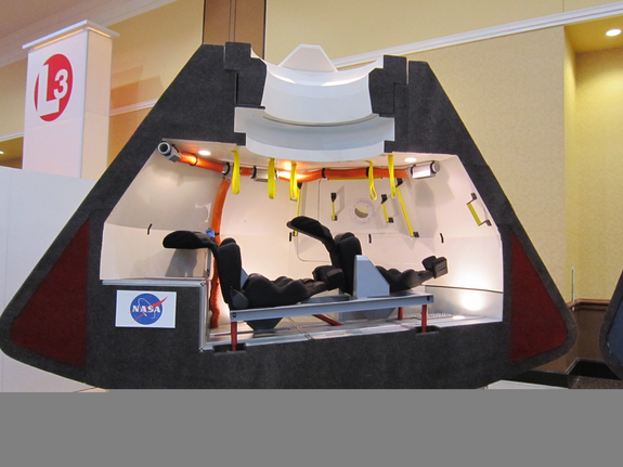 A model of Boeing's CST-100 space capsule shows the crew-carrying craft's interior design. The CST-100, which can carry up to seven astronauts, could fly its first manned mission by 2015 or 2016, Boeing officials have said.