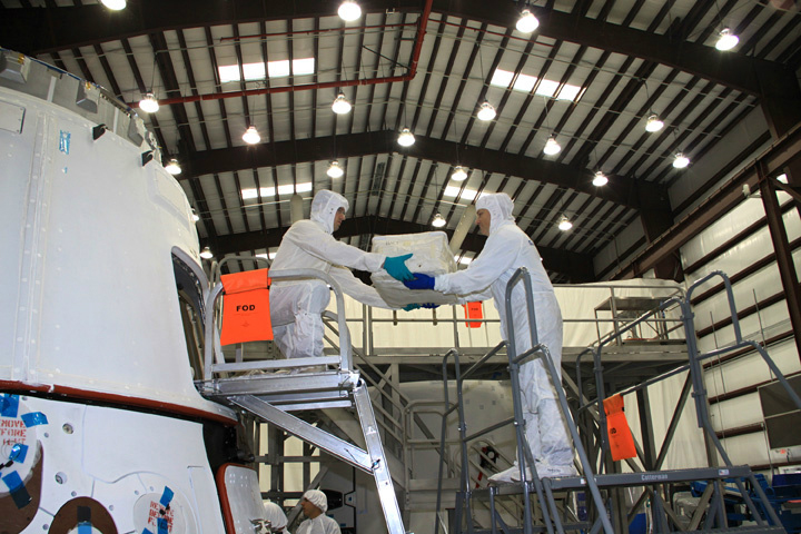 Workers Loading Cargo Aboard Dragon Capsule