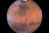 The north polar sand sea and the Acidalia Planitia (the large, dark region in the center) of Mars are primarily composed of glass.