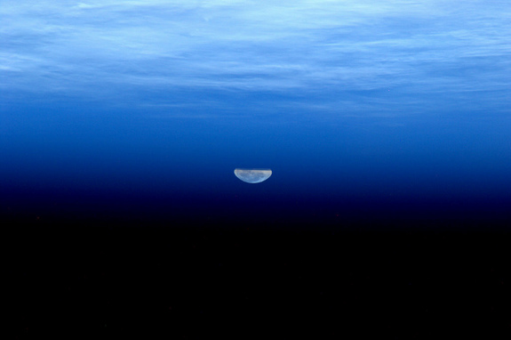 Flattened moonbeams appear to look like liquid in this image of the supermoon. The image was taken by André Kuipers from aboard the ISS on May 5, 2012.