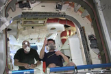 NASA astronaut Don Pettit (left) and Russian cosmonaut Oleg Kononenko pose for a photo after entering SpaceX's Dragon capsule on the International Space Station for the first time on May 26, 2012.