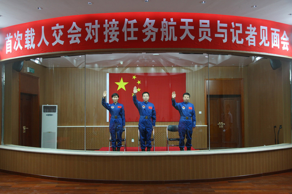The crew of China's Shenzhou-9 mission, set to launch in June 2012, waves. L to R, Liu Yang (China's first female astronaut), Jing Haipeng, Liu Wang.