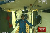 China's Shenzhou 9 mission commander Jing Haipeng waves to a camera after boarding the Tiangong 1 space module following a successful June 18, 2012 docking, China's first manned orbital rendezvous, in this view from state-run TV news.