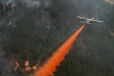 A U.S. Air Force C-130 Hercules aircraft uses a modular airborne firefighting system to spread fire retardant on the Waldo Canyon wildfire in Colorado Springs, Colo., on June 28, 2012. The Waldo Canyon fire, which started June 23, has burned several hundred homes and forced large-scale evacuations in Colorado Springs.
