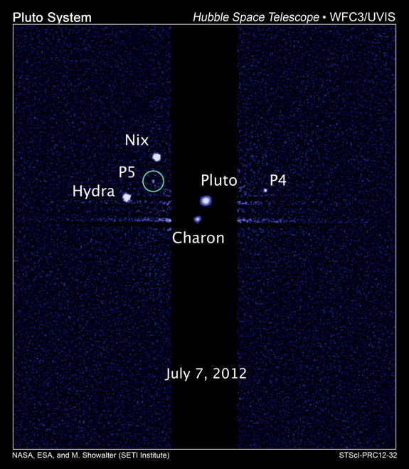 This image, taken by NASA's Hubble Space Telescope, shows five moons orbiting the distant, icy dwarf planet Pluto. The green circle marks the newly discovered moon, designated P5, as photographed by Hubble's Wide Field Camera 3 on July 7, 2012.