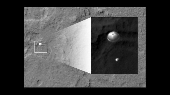 NASA's Curiosity rover and its parachute were spotted by NASA's Mars Reconnaissance Orbiter as Curiosity descended to the surface on Aug. 5 PDT (Aug. 6 EDT). The High-Resolution Imaging Science Experiment (HiRISE) camera captured this image of Curiosity while the orbiter was listening to transmissions from the rover.