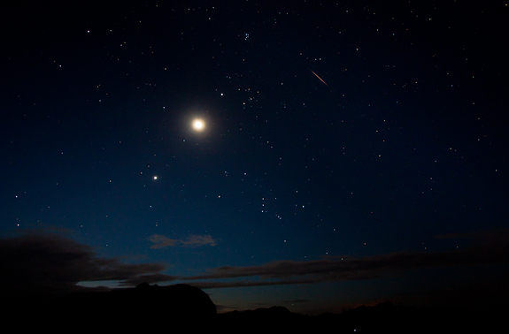 The moon and Venus shine bright alongside a Perseid meteor (upper right) on Aug. 12 in this view by photographer Tyler Leavitt in Las Vegas, Nevada, during the peak of the 2012 Perseid meteor shower on Aug. 12.