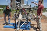 Marshall Center engineers Logan Kennedy, right, and Adam Lacock check out the lander prototype, dubbed the "Mighty Eagle." Since its last round of tests in 2011, the Mighty Eagle team has made significant updates to the guidance controls on the lander's camera, furthering its autonomous capabilities. Testing will continue through the month of August.