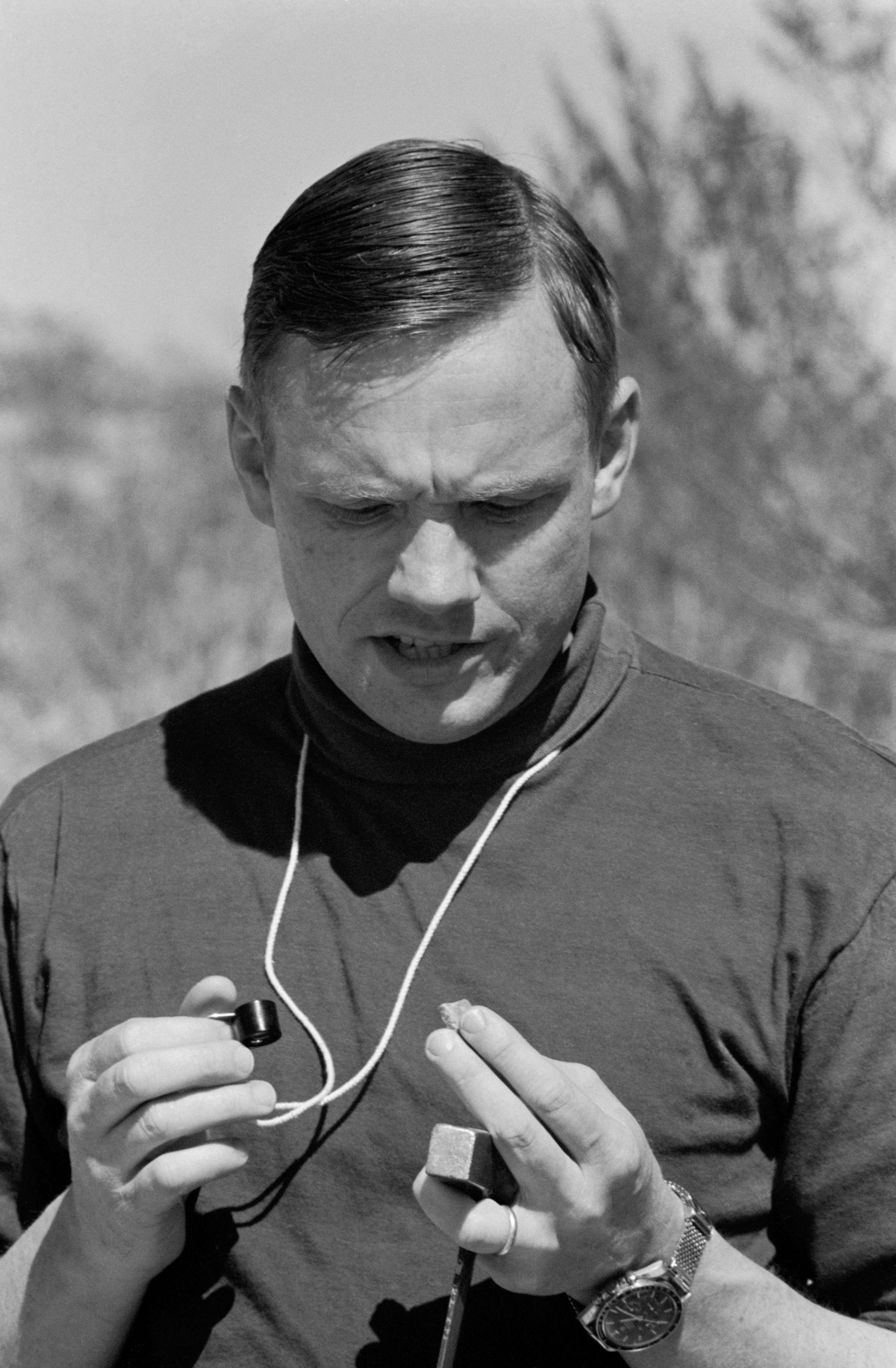 Neil Armstrong Studies Rock Sample