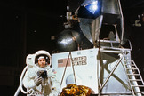 Astronaut Neil A. Armstrong, wearing an Extravehicular Mobility Unit, participates in a simulation of deploying and using lunar tools on the surface of the moon during a training exercise in Building 9 on April 22, 1969. Armstrong is the commander of the Apollo 11 lunar landing mission. In the background is a Lunar Module mock-up.