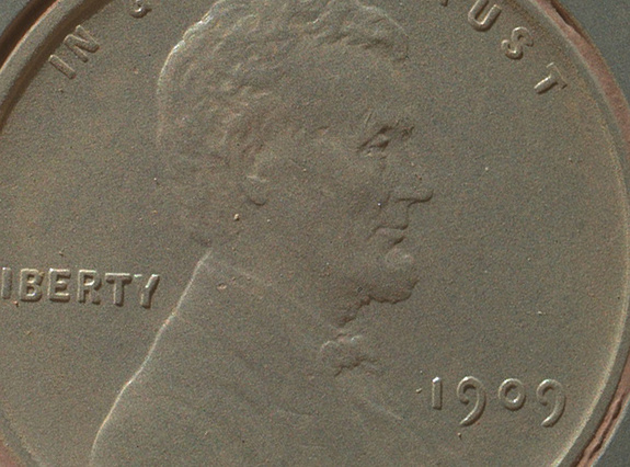 This close-up image shows Martian sand grains that settled on the penny that serves as a calibration target on NASA's Curiosity rover. Image released September 12, 2012.