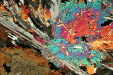 Cross-polarized transmitted-light image of a lunar rock reveals its hidden beauty. In broad daylight the rocks are an unprepossessing – even an ugly – gray. Image released Oct. 17. 2012.