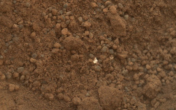 This image shows part of the small pit or bite created when NASA's Mars rover Curiosity collected its second scoop of Martian soil at a sandy patch called "Rocknest." This image was taken by the Mars Hand Lens Imager (MAHLI) camera on Curiosity's arm during the 69th Martian day, or sol, of the mission (Oct. 15, 2012).