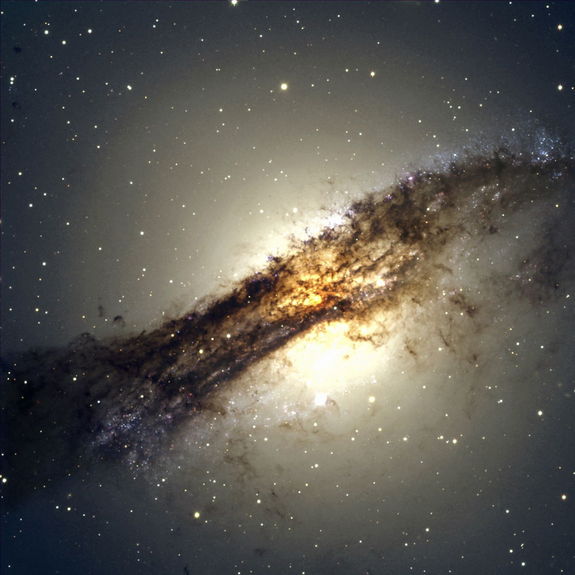 The giant elliptical galaxy Centaurus A shows a split personality because it hides a gaseous spiral at its core. When Centaurus A collided with a spiral galaxy 300 million years ago, it slurped up the spiral's gases, which formed a new spiral inside the larger galaxy. Image released Oct. 22, 2012.