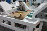 A NASA engineer works on a mockup of the sled component of the SEV spacecraft, attaching wiring onto this preliminary prototype.