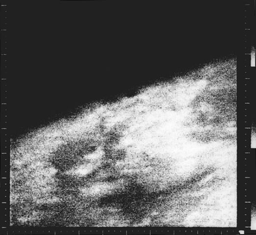 This is the first close-up image ever taken of Mars. It shows an area about 330 km across by 1200 km (205 miles by 745 miles) from limb to bottom of frame, centered at 37 N, 187 W. The area is near the boundary of Elysium Planitia to the west and Arcadia Planitia to the east.