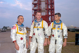 Astronauts (left to right) Gus Grissom, Ed White, and Roger Chaffee posing in front of Launch Complex 34.