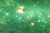 This image from NASA's Spitzer Space Telescope shows a newly identified "bone" of dust and gas in the Milky Way galaxy's skeleton. The structure, visible toward the bottom of the frame, is about 300 light-years long but just 1 or 2 light-years wide.