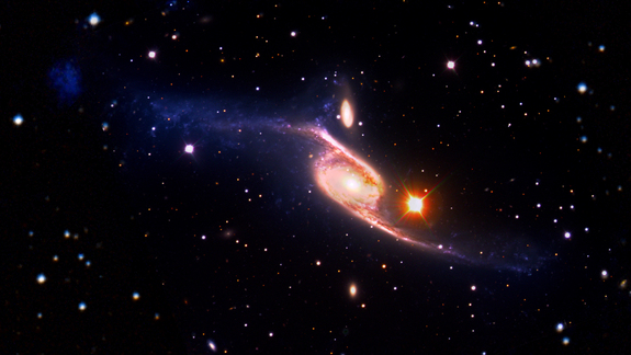This composite of the spiral galaxy NGC 6872 combines visible light images from the European Southern Observatory's Very Large Telescope with far-ultraviolet data from NASA's GALEX and infrared data acquired by NASA's Spitzer Space Telescope. The spiral is 522,000 light-years across from armtip to armtip, which makes NGC 6872 about 5 times the size of the Milky Way.