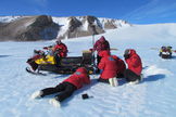 Scientists work to gather meteorites in this scene from a recent meteorite-hunting season of the Antarctic Search for Meteorites Program run by Case Western Reserve University.