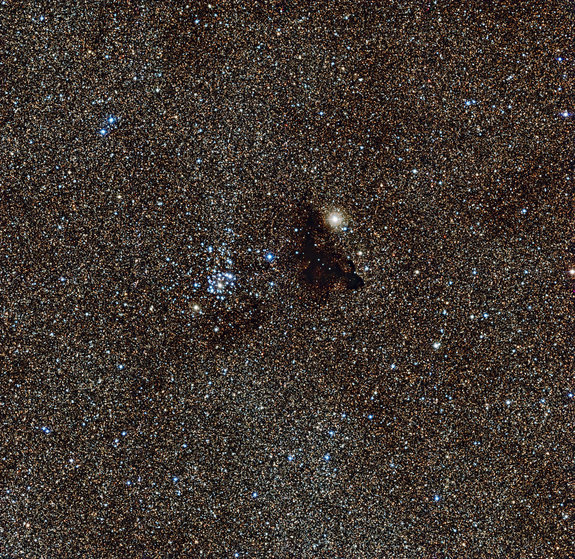 The dark nebula Barnard 86 (right) and the star cluster NGC 6520 (left) make a beautiful cosmic pairing.