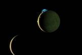 This is a composite image of Jupiter's volcanic moon Io and Europa taken during a March 2, 2007 flyby by NASA's New Horizons spacecraft. Here Io (top) steals the show with its beautiful display of volcanic activity. Three volcanic plumes are visible. Most conspicuous is the enormous 300-kilometer (190-mile) high plume from the Tvashtar volcano at the 11 o'clock position on Io's disk.