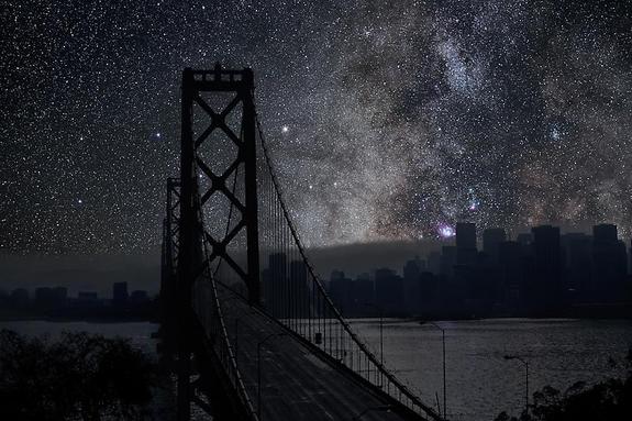 The Milky Way and California's San Francisco-Oakland Bay Bridge stand out prominently in this cityscape. The sky photo was taken in the Mojave Desert.