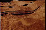 The surface of Venus, generated here using data from NASA’s Magellan mission, undergoes resurfacing through weathering processes such as volcanic activity, meteorite impacts and wind erosion. (Black areas represent missing data).