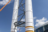 Solid rocket booster replicas are topped with nose cones outside the Space Shuttle Atlantis exhibit at the Kennedy Space Center Visitor Complex in Florida.