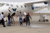 New Virgin Galactic pilot C.J. Sturckow, a four-time space shuttle astronaut, gets a traditional dousing after flying the company's WhiteKnightTwo mothership for the first time on May 9, 2013.