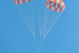 A model of NASA’s Orion spacecraft glides to a successful touchdown during a test of its parachute system on May 1, 2013. Orion's three main parachutes, which gradually slow the capsule for landing, weigh 300 pounds each and can cover almost an entire football field.