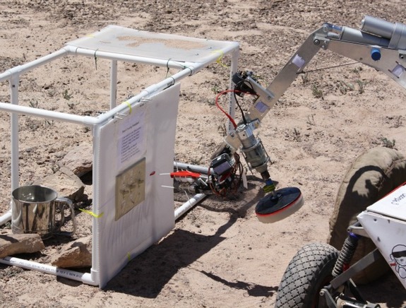 Scorpio 3 uses its brush attachment to clean the solar panel.