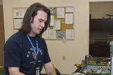 NASA life support engineering technician Joshua Graham performs a pre-flight inspection of a pressure suit.