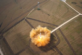 SpaceX's reusable Grasshopper rocket prototype rises skyward from its McGregor, Texas launch pad during a June 14, 2013 test flight that reached 1,066 feet (325 meters) before descending back to Earth. This still was taken from a video recorded by a small unmanned hexacopter.