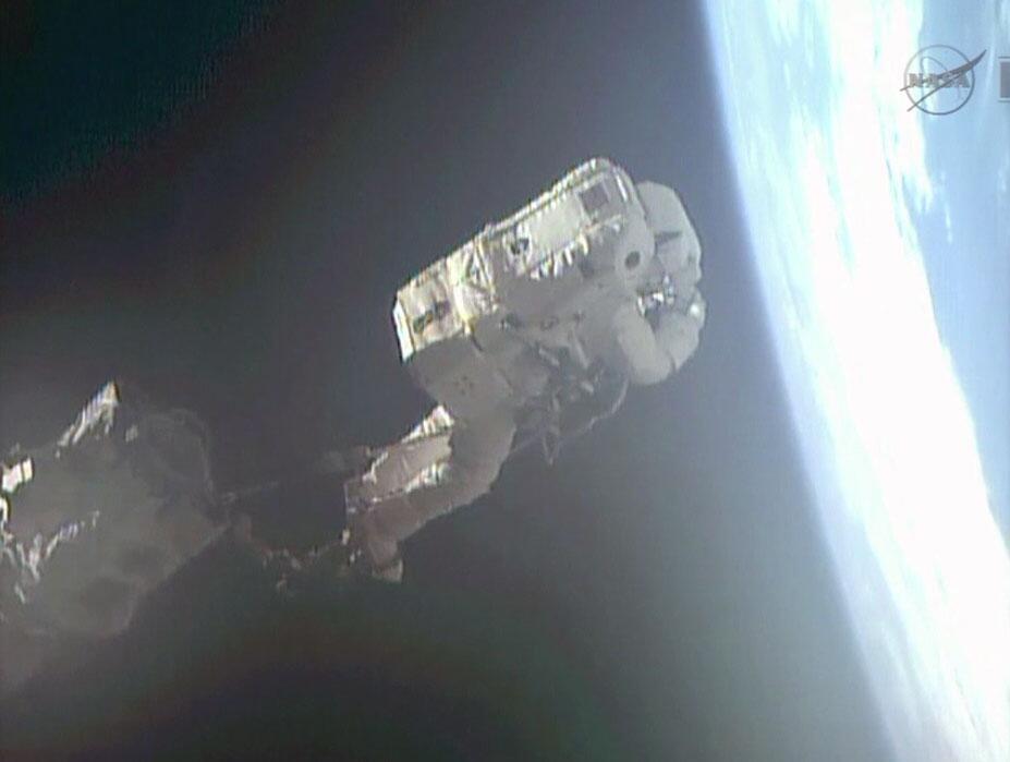 Astronaut on Space Station's Robotic Arm