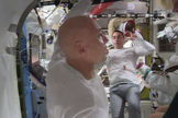 Astronauts Parmitano (foreground) and Cassidy (background) wrap-up the spacewalk of July 16, 2013, which ended prematurely owing to water leaking inside Parmitano's helmet.