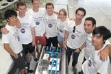 Engineering students with the UCSD Microgravity Team from the University of California, San Diego, stands near their biofuel experiment to test weightless flames ahead of a NASA Microgravity University flight at Ellington Field in Houston. The are: (clockwise from left): Joshua Siu, Sam Avery, Jack Goodwin, Andrew Beeler, Daneesha Kenyon, Joshua Sullivan, Nico Montoya, and Victor Hong. NASA mentor Christina Gallegos is not pictured. Image taken on July 18, 2013.