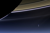 This rare image taken on July 19, 2013, by NASA's Cassini spacecraft has shows Saturn's rings and our planet Earth and its moon in the same frame. At the time, Cassini was 2013 from a distance of about 898.414 million miles (1.445858 billion kilometers) from Earth. It is only one footprint in a mosaic of 33 footprints covering the entire Saturn ring system (including Saturn itself) taken by Cassini's wide-angle camera.